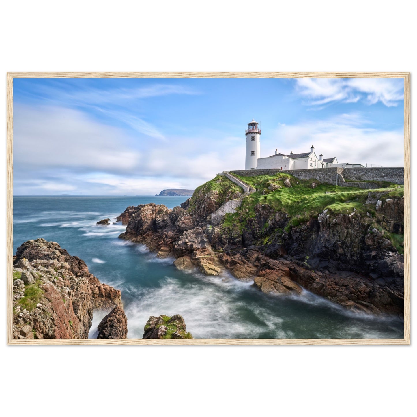 Capture the breathtaking beauty of Fanad Head Lighthouse in Co. Donegal, Ireland with our framed print. This captivating piece beautifully portrays the iconic landmark, offering a slice of Ireland's rugged coastal charm for your home decor.