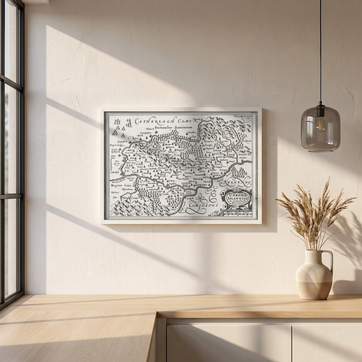 Barony of Idrone, County Carlow c.1600 Map by Van den Keere Print framed print in a white frame on a plaster wall above an oak worktop in a bright Scandinavian kitchen