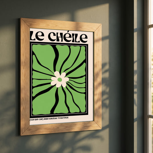 Le Chéile framed print in a natural oak frame on a dark green wall beside a window, dappled plant shadow