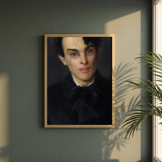 Portrait of W.B. Yeats framed print in a natural oak frame on a dark green wall beside a window, dappled plant shadow