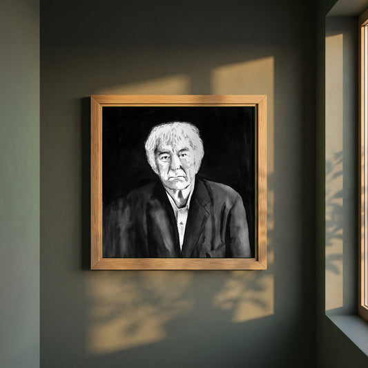 Seamus Heaney framed print in a natural oak frame on a dark green wall beside a window, dappled plant shadow