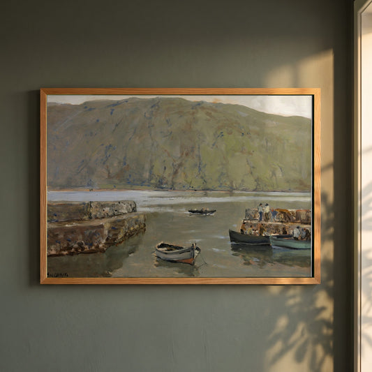 The Harbour, Leenane framed print in a natural oak frame on a dark green wall beside a window, dappled plant shadow