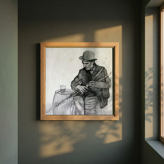Uilleann Piper framed print in a natural oak frame on a dark green wall beside a window, dappled plant shadow