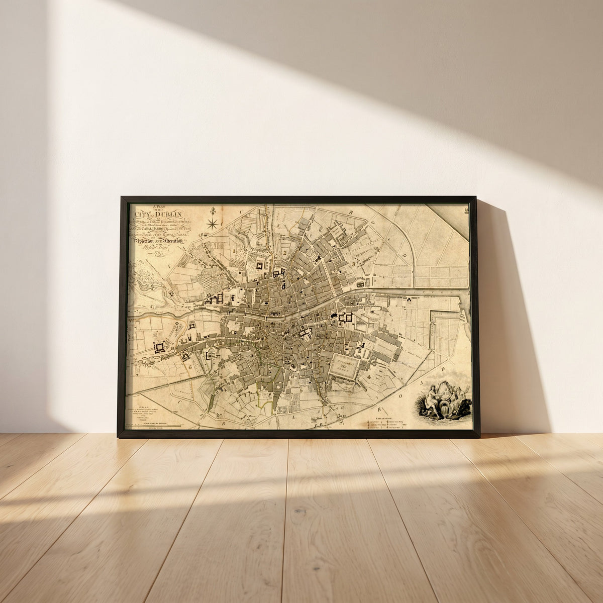 1797 Dublin Map framed print in a black frame leaning against a white plaster wall on oak floorboards in morning light