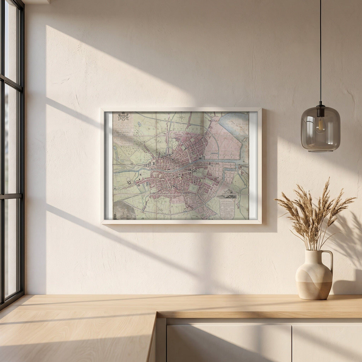 1798 Dublin Map framed print in a white frame on a plaster wall above an oak worktop in a bright Scandinavian kitchen