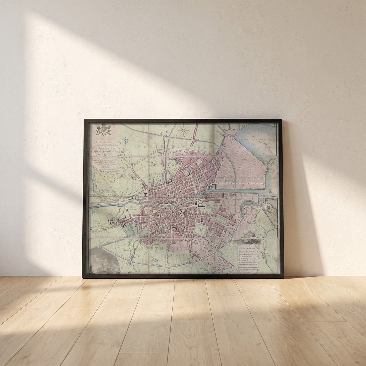 1798 Dublin Map framed print in a black frame leaning against a white plaster wall on oak floorboards in morning light