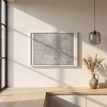 1830 Dublin Map by John Kirkwood framed print in a white frame on a plaster wall above an oak worktop in a bright Scandinavian kitchen