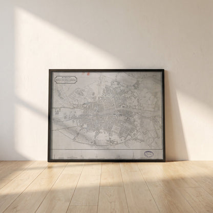 1830 Dublin Map by John Kirkwood framed print in a black frame leaning against a white plaster wall on oak floorboards in morning light