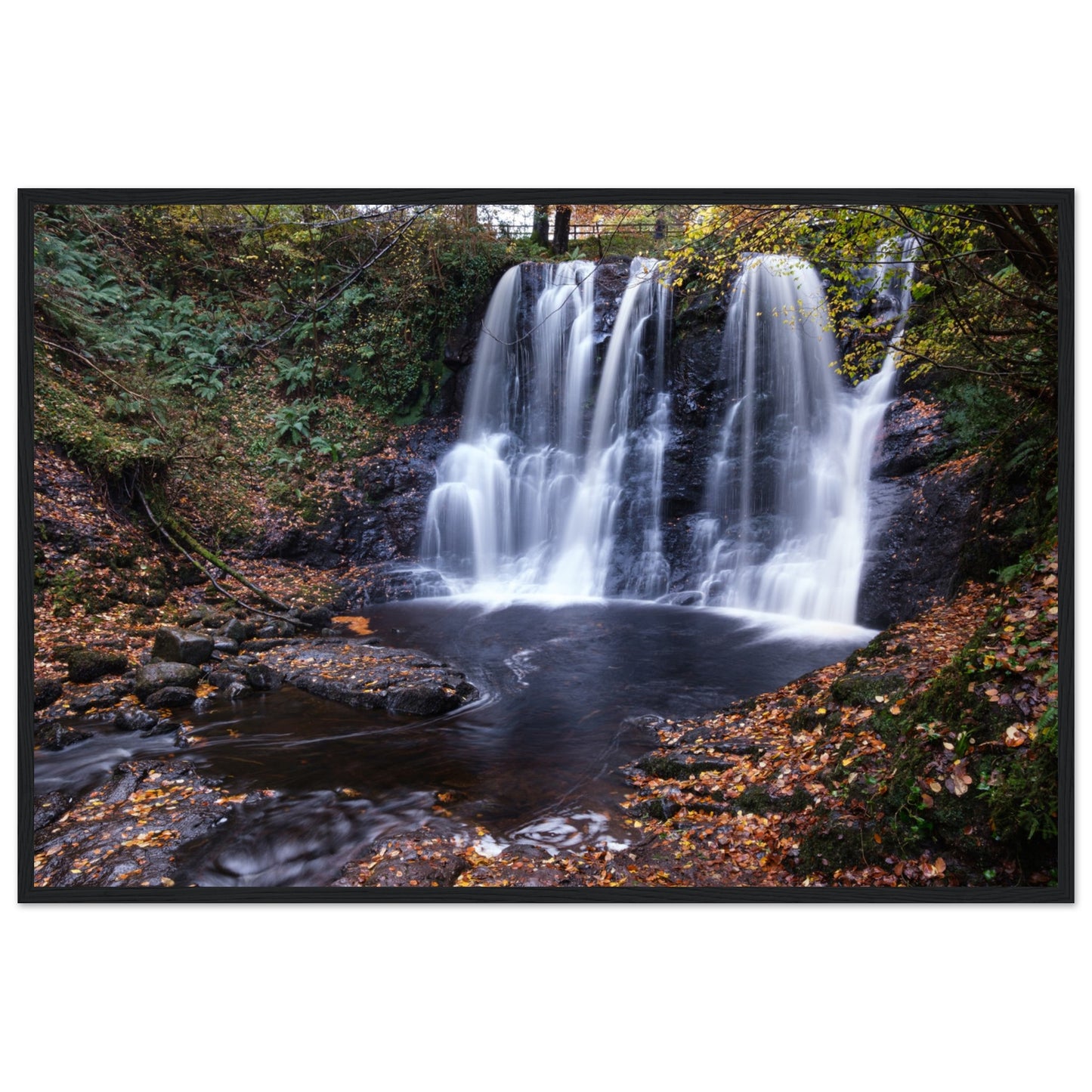 Framed print of Glenariff Waterfall, capturing the serene beauty of cascading water amidst lush greenery in the Glens of Antrim, Northern Ireland. Known as the 'Queen of the Glens,' this stunning landscape print brings nature's tranquility into your home.