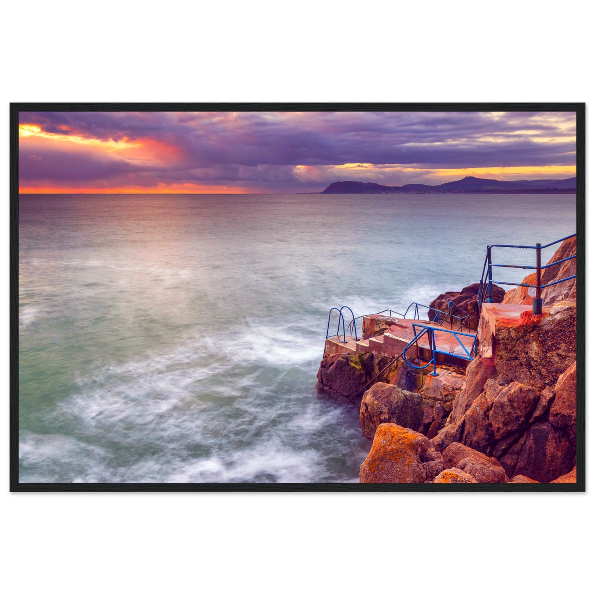 Framed wall art print of Vico Baths in Dalkey, Dublin. Features serene coastal scenery with clear waters and natural rock formations, capturing the iconic outdoor swimming spot. Perfect for adding a touch of Irish coastal beauty to any room.