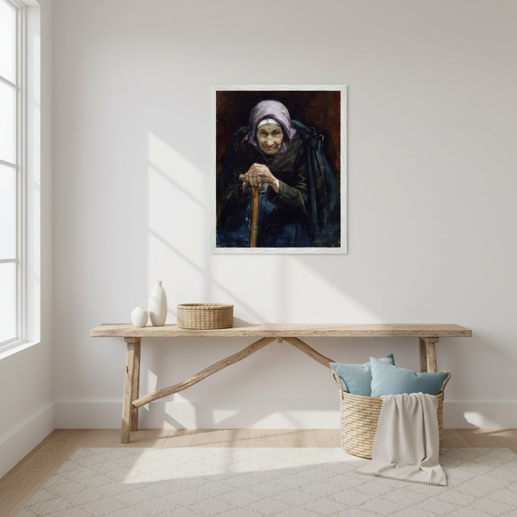 Fine art print of The Fisherman’s Mother in a crisp white frame displayed in a bright coastal-inspired interior. White walls, driftwood textures, woven baskets, soft blue accents, natural lighting. Calm, airy setting suitable for a modern home. Styled as a lifestyle decor photograph.