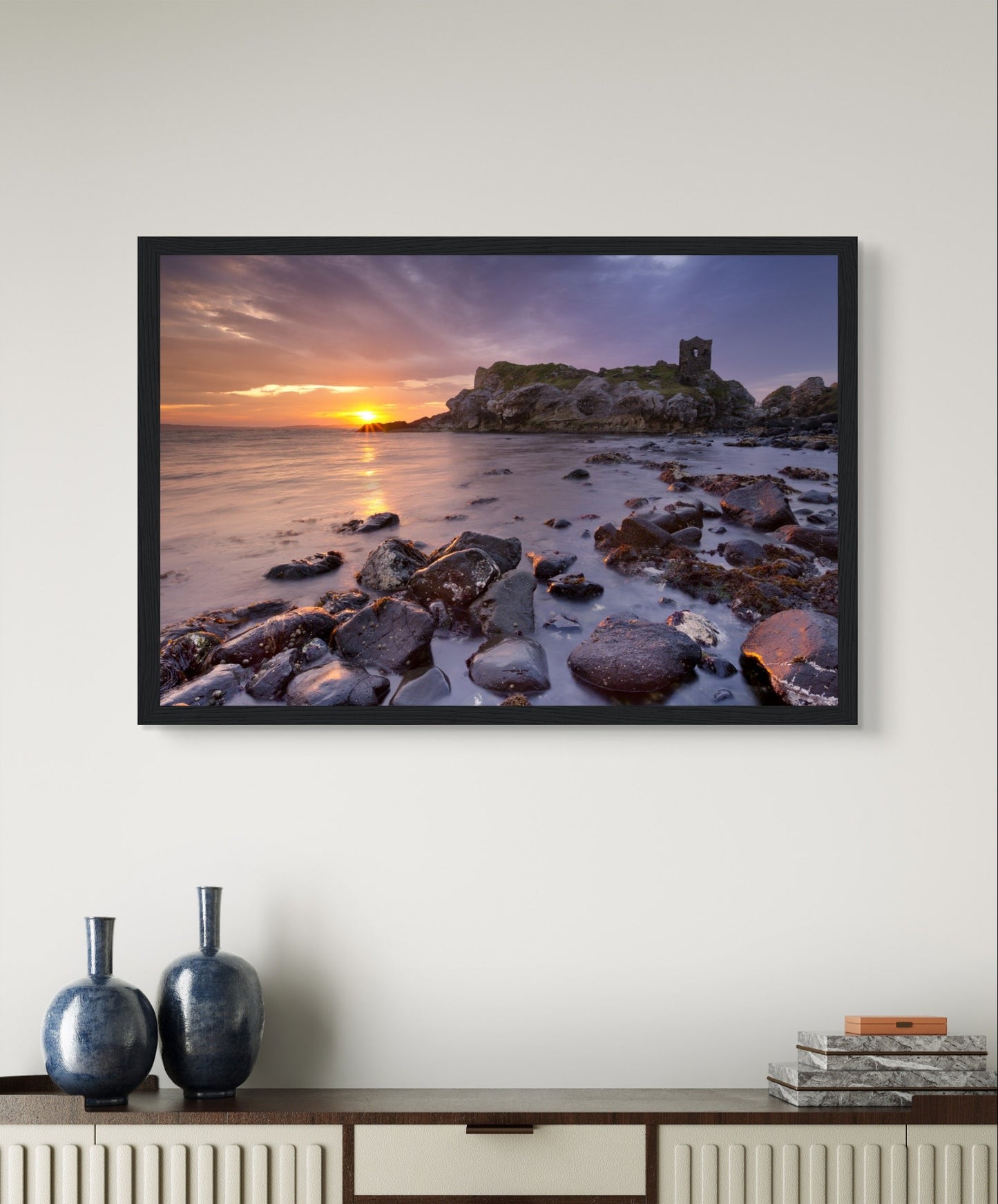 A framed print of Kinbane Castle perched on a dramatic cliffside, overlooking the crashing waves of the North Atlantic. This stunning coastal wall art captures the rugged beauty and historical charm of Ireland, perfect for adding a touch of history to any space.