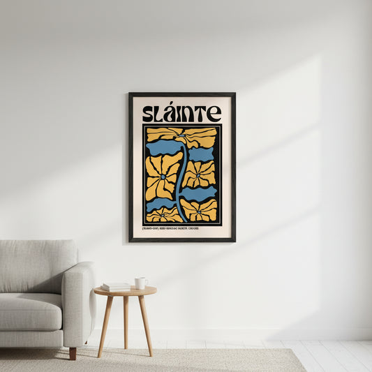 Framed Sláinte print in a black or natural wood frame on a clean white wall in a minimalist living room. Soft natural daylight, modern styling, vibrant colours popping.