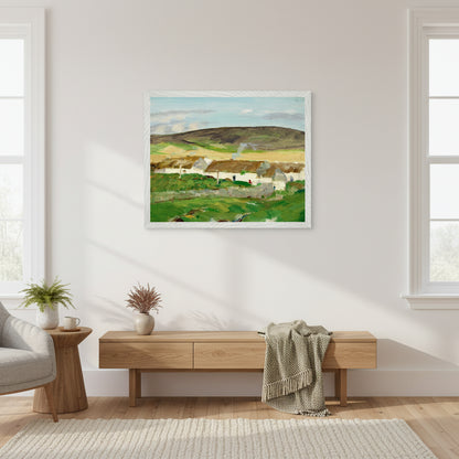 Museum-quality framed Irish cottage landscape print styled in a Scandinavian-Irish fusion living room, white walls, oak furniture, soft morning light, minimal but warm.