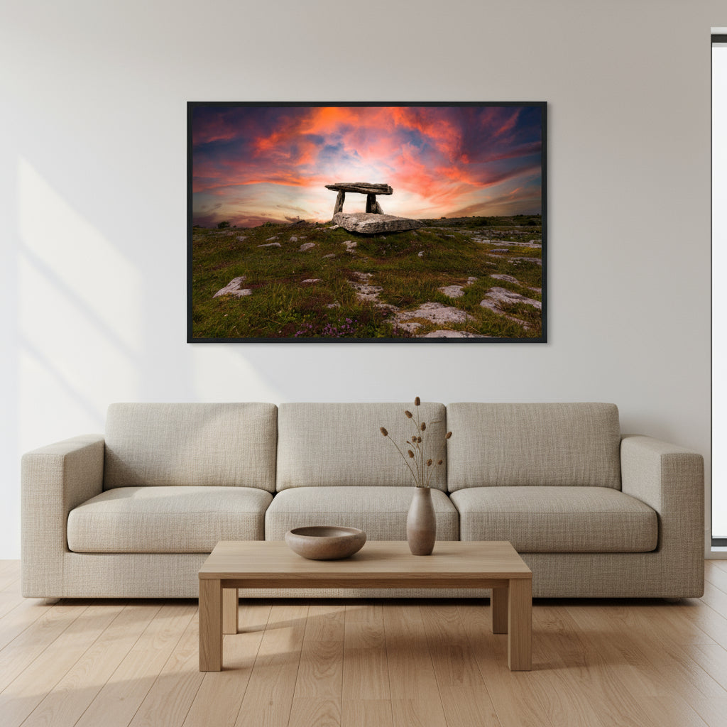 Large 60×90 cm dolmen print in a black frame centred on a white wall, light oak flooring, neutral linen sofa and subtle Irish pottery on a coffee table.