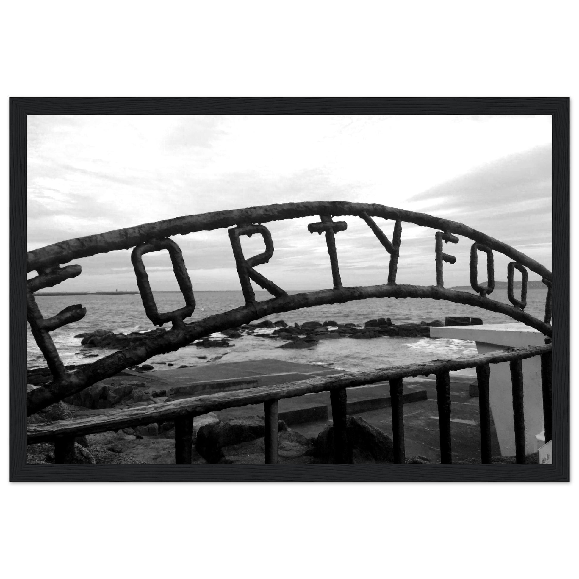 Stunning coastal scene featuring The Forty Foot in Dublin, Ireland. Martello tower stands against blue sky, inviting sea. Gender-inclusive bathing spot. Premium framed print on archival paper.