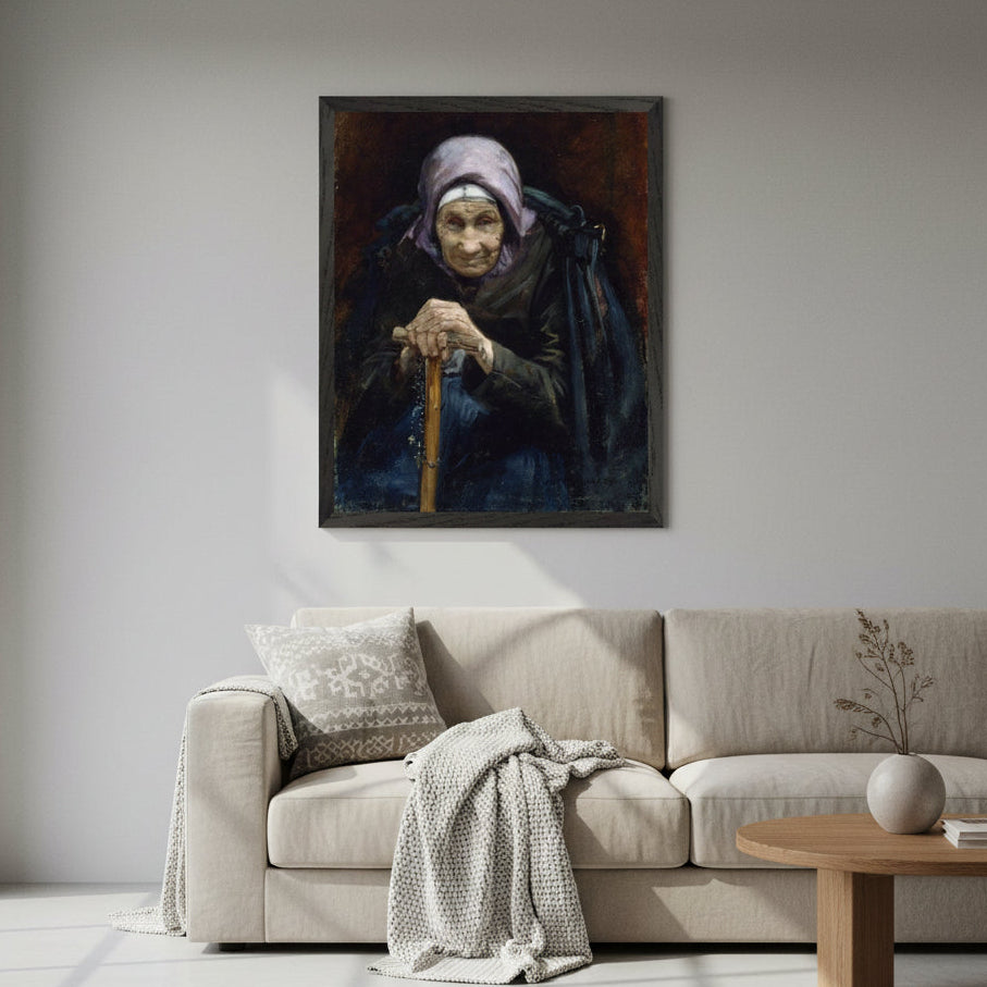 Museum-quality reproduction of The Fisherman’s Mother by Helen Mabel Trevor in a slim black modern frame, hanging on a white or light-grey wall. Minimalist Nordic lounge setting, soft shadows, diffused window light, beige sofa, muted textiles. Clean, modern styling with subtle heritage undertones. High-end lifestyle photography.
