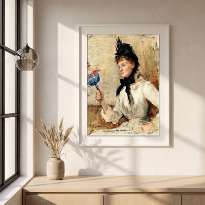 A Lady Holding a Rattle framed print in a white frame on a plaster wall above an oak worktop in a bright Scandinavian kitchen