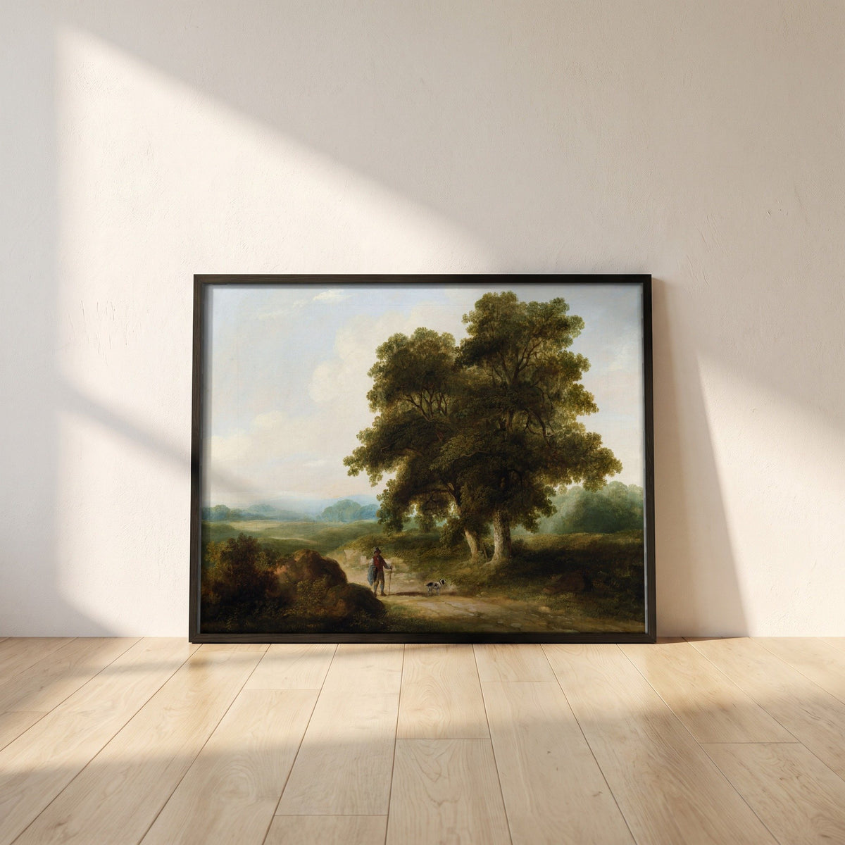 A Landscape, Homeward Bound framed print in a black frame leaning against a white plaster wall on oak floorboards in morning light