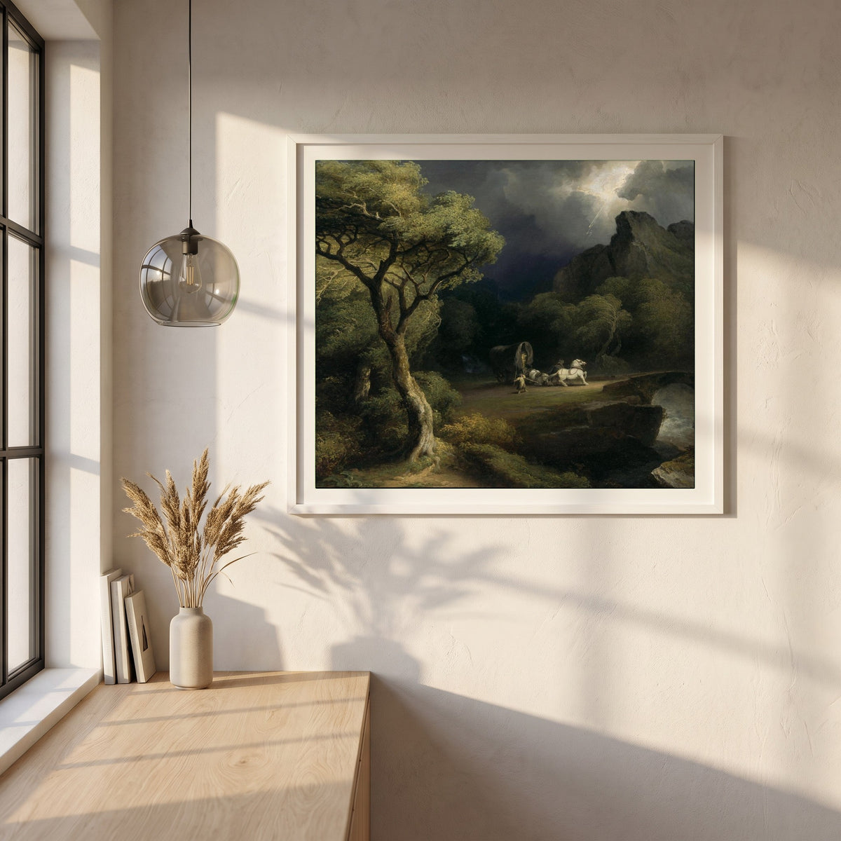 A Thunderstorm framed print in a white frame on a plaster wall above an oak worktop in a bright Scandinavian kitchen