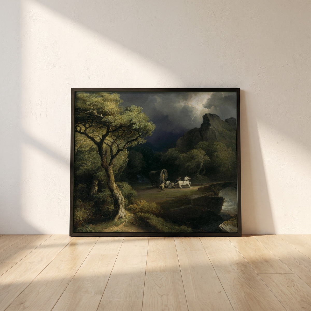A Thunderstorm framed print in a black frame leaning against a white plaster wall on oak floorboards in morning light