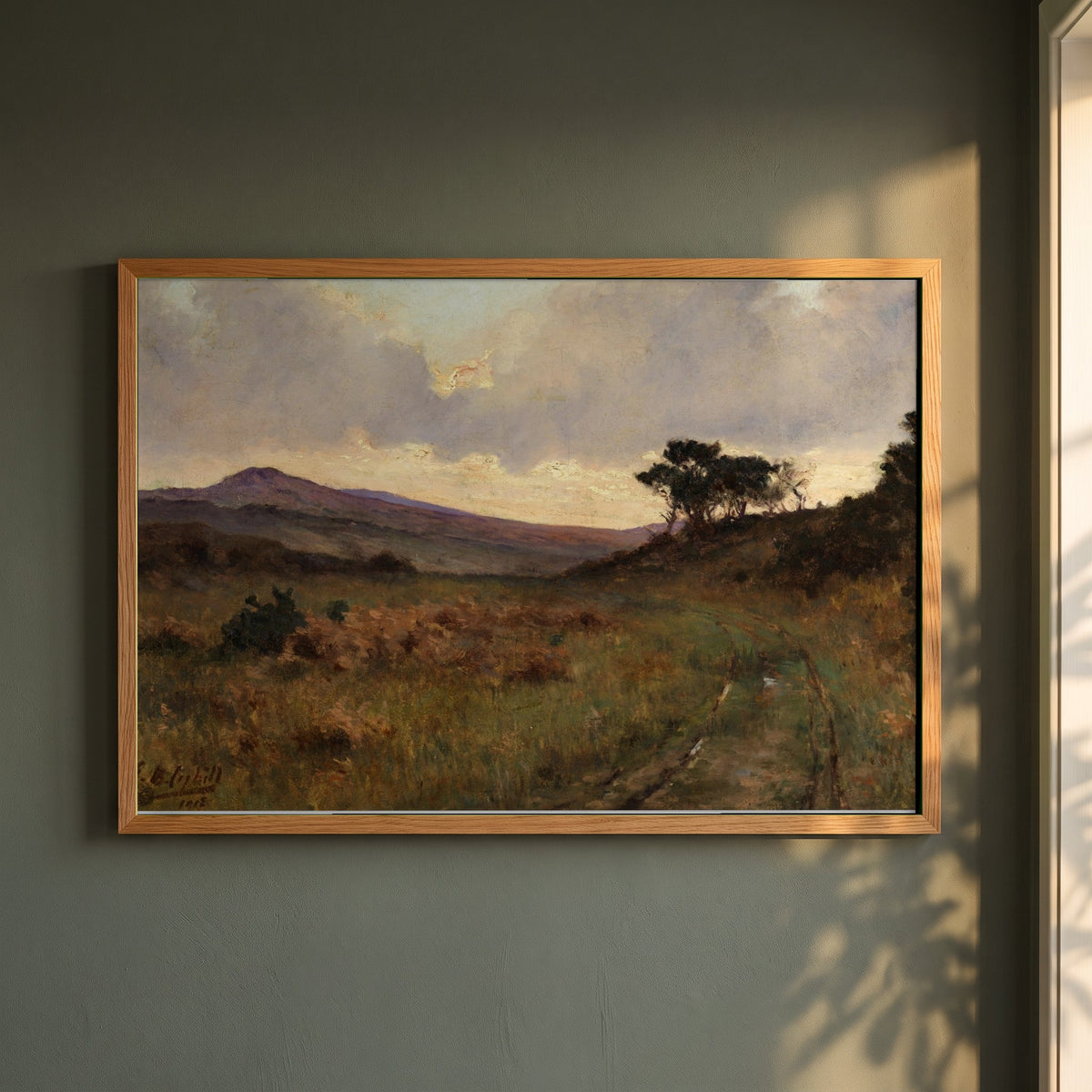 Castletownshend, County Cork framed print in a natural oak frame on a dark green wall beside a window, dappled plant shadow
