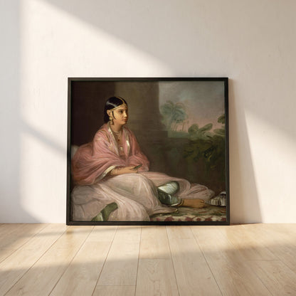 An Indian Lady framed print in a black frame leaning against a white plaster wall on oak floorboards in morning light