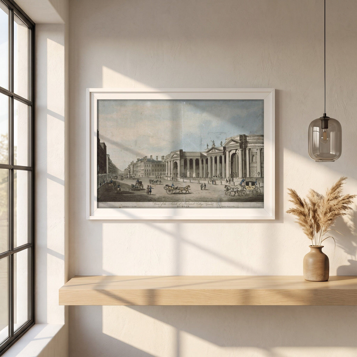 Bank of Ireland, College Green framed print in a white frame on a plaster wall above an oak worktop in a bright Scandinavian kitchen