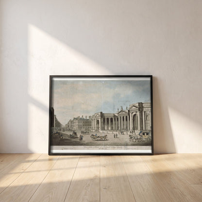 Bank of Ireland, College Green framed print in a black frame leaning against a white plaster wall on oak floorboards in morning light