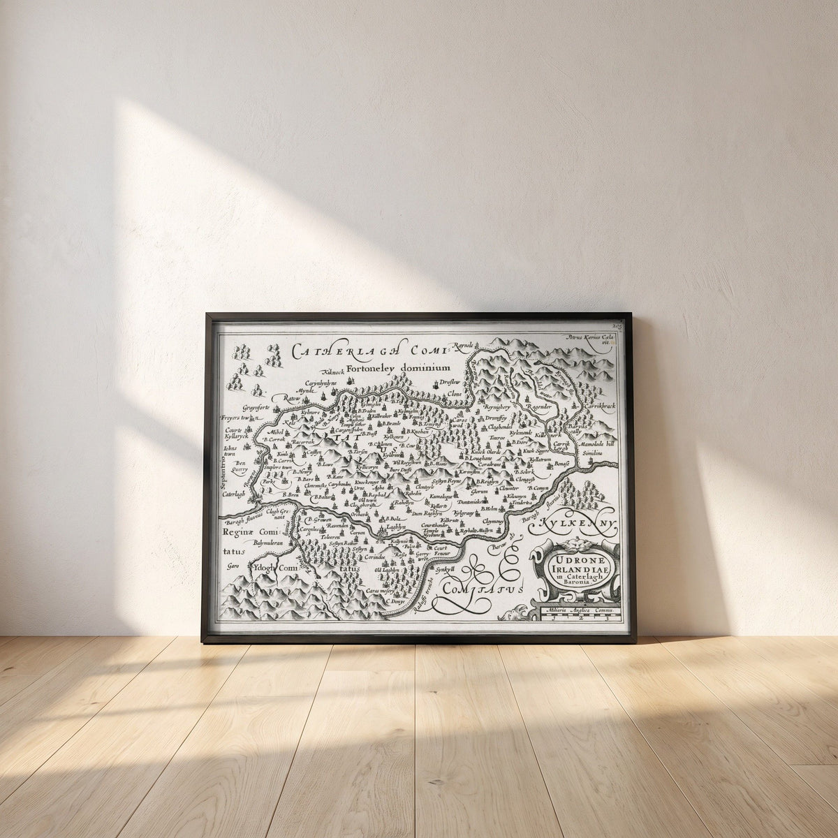 Barony of Idrone, County Carlow c.1600 Map by Van den Keere Print framed print in a black frame leaning against a white plaster wall on oak floorboards in morning light