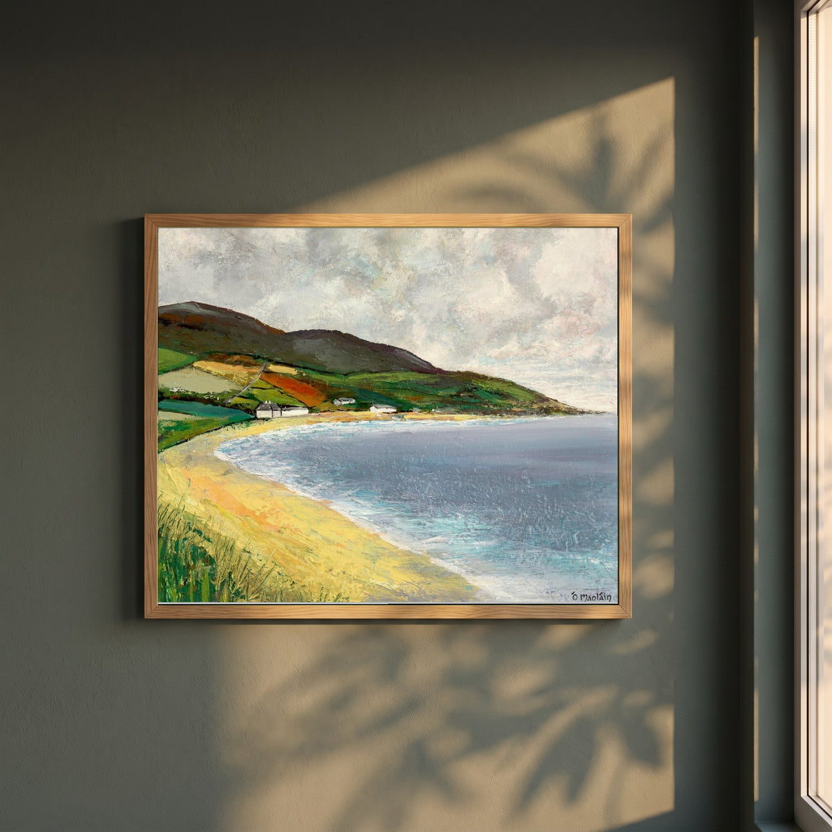 Cushendun Beach, County Antrim framed print in a natural oak frame on a dark green wall beside a window, dappled plant shadow