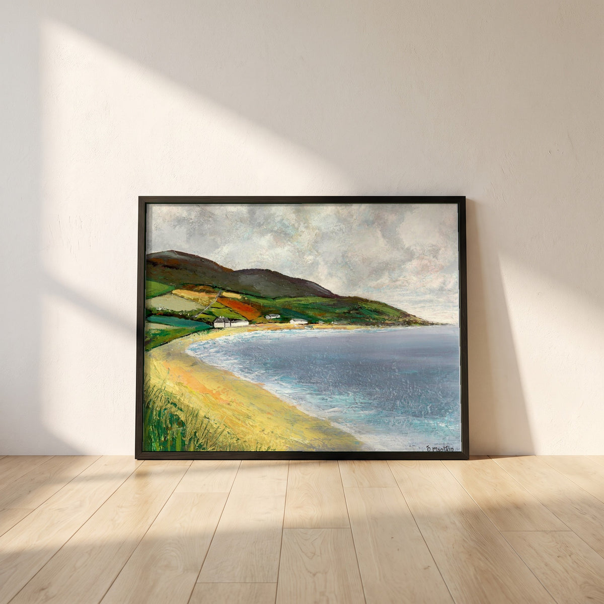 Cushendun Beach, County Antrim framed print in a black frame leaning against a white plaster wall on oak floorboards in morning light