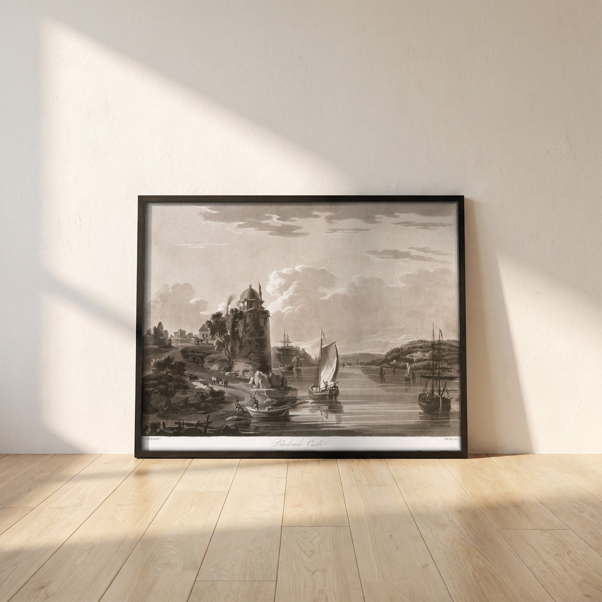 Blackrock Castle 1796 by Thomas Sautelle Roberts Art Print framed print in a black frame leaning against a white plaster wall on oak floorboards in morning light