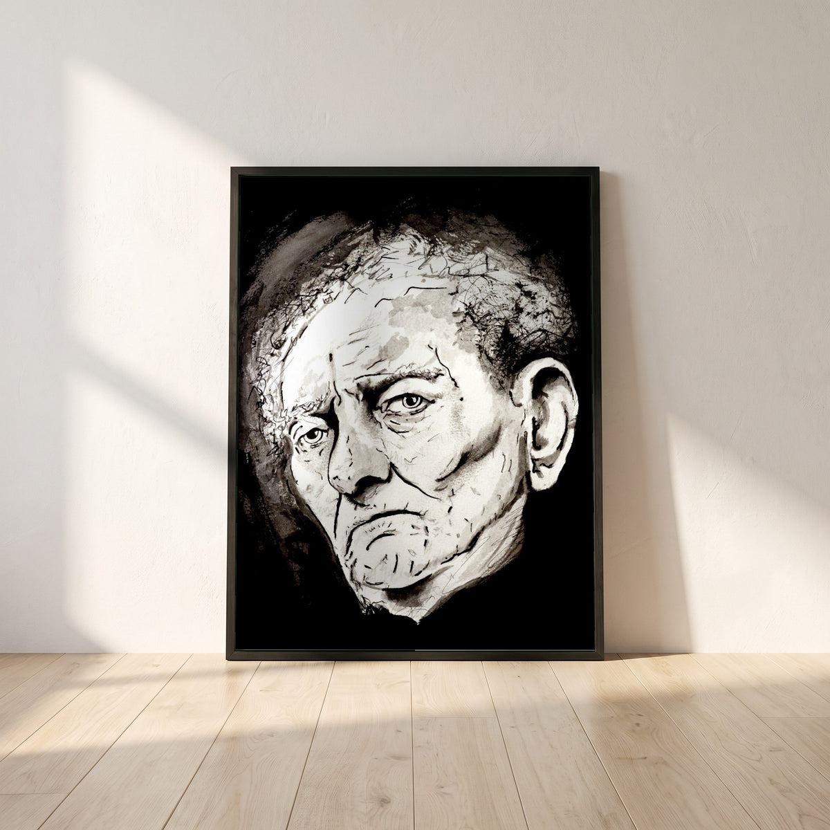 Brian Friel framed print in a black frame leaning against a white plaster wall on oak floorboards in morning light