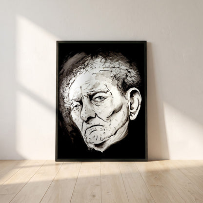 Brian Friel framed print in a black frame leaning against a white plaster wall on oak floorboards in morning light
