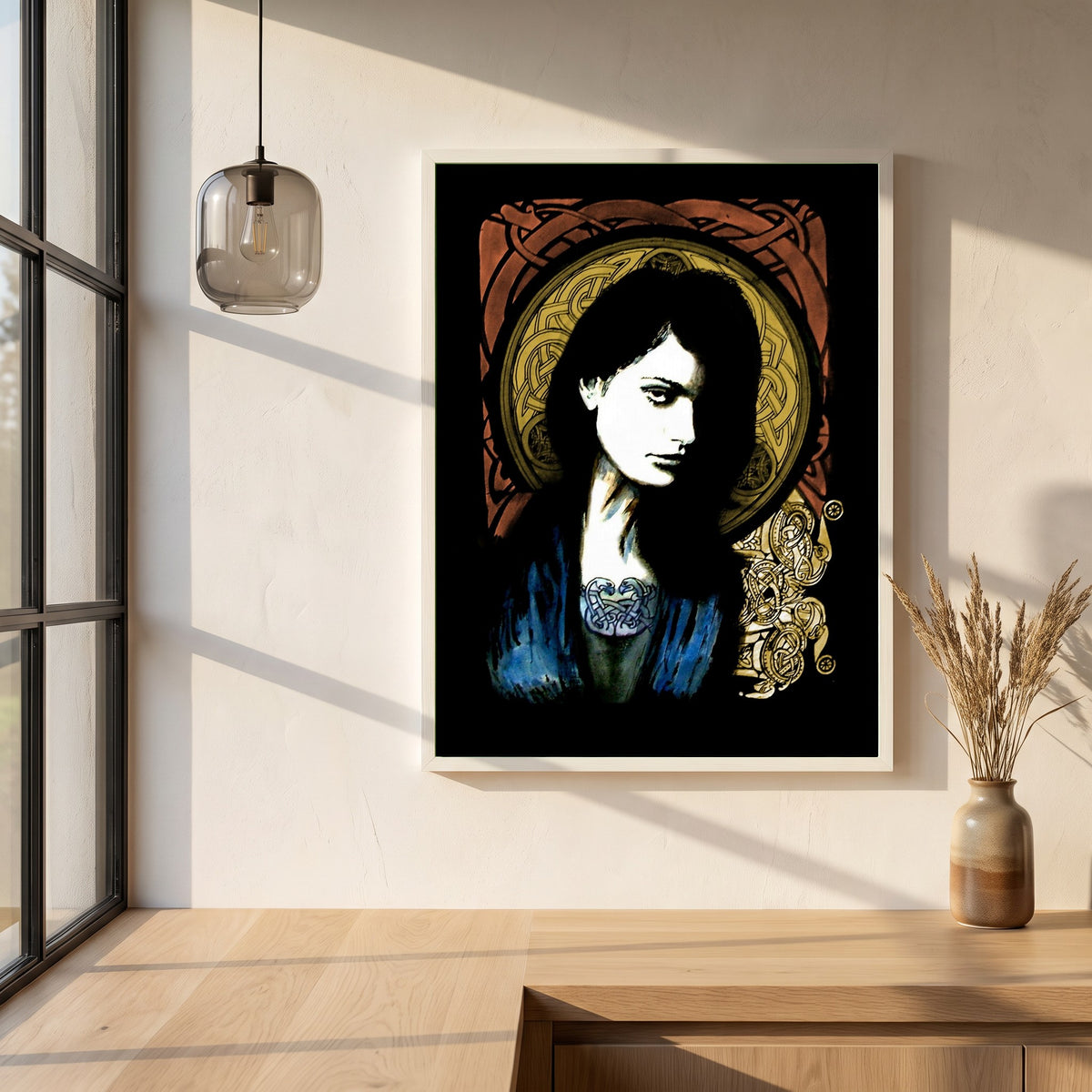 Celtic Goddess framed print in a white frame on a plaster wall above an oak worktop in a bright Scandinavian kitchen