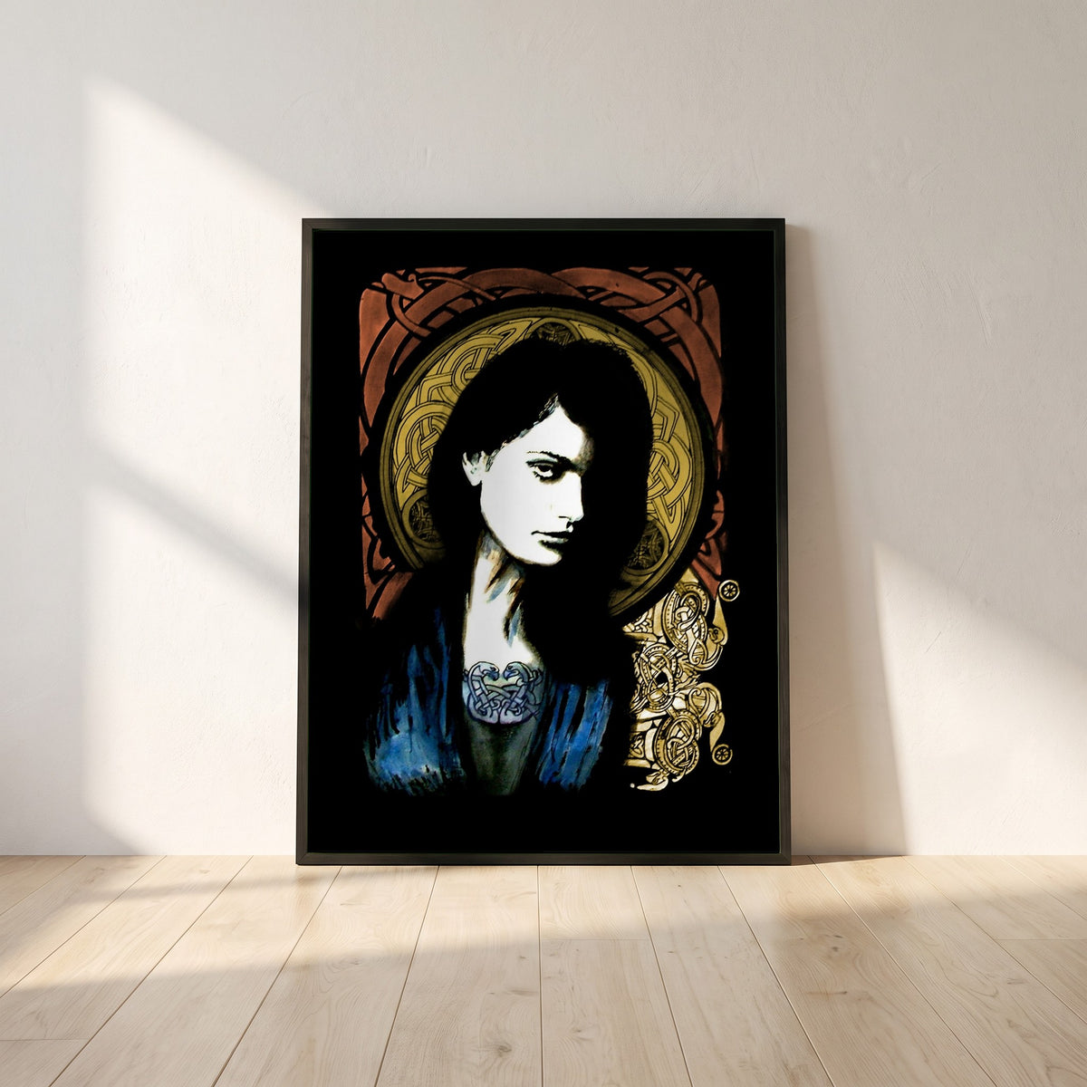 Celtic Goddess framed print in a black frame leaning against a white plaster wall on oak floorboards in morning light