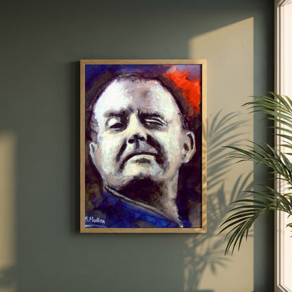Christy Moore framed print in a natural oak frame on a dark green wall beside a window, dappled plant shadow