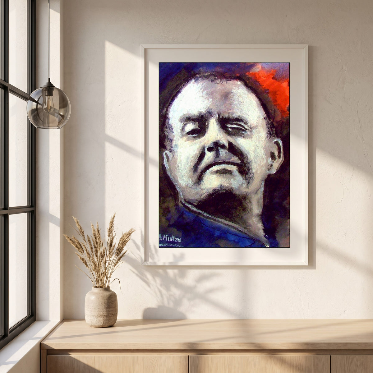Christy Moore framed print in a white frame on a plaster wall above an oak worktop in a bright Scandinavian kitchen