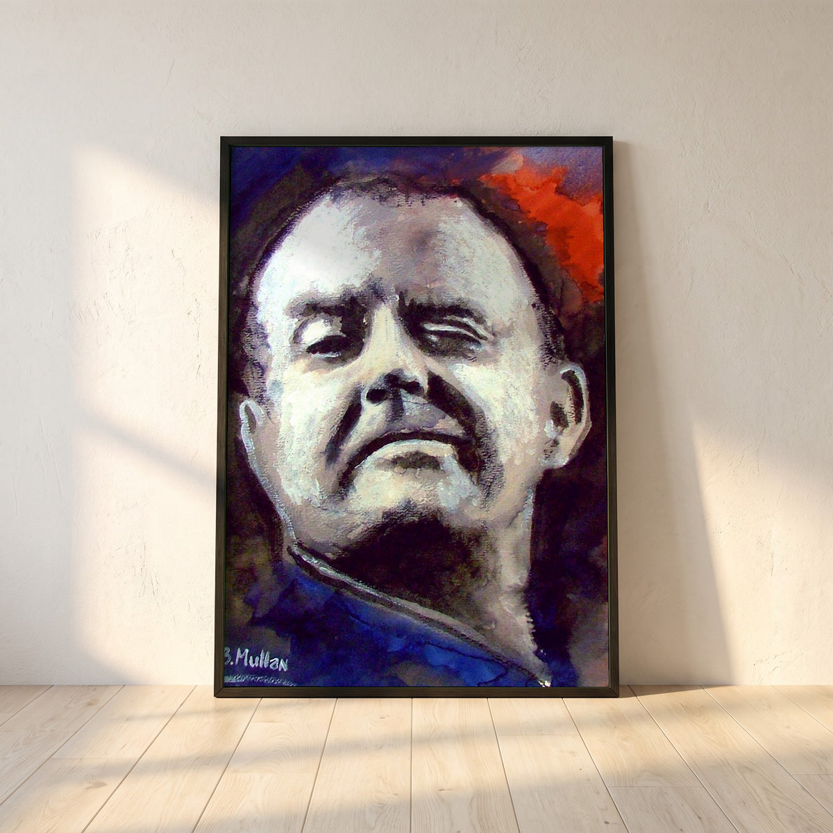 Christy Moore framed print in a black frame leaning against a white plaster wall on oak floorboards in morning light