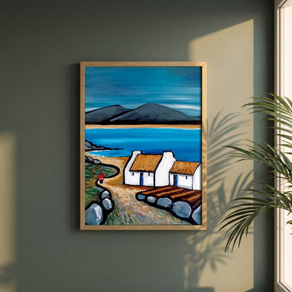 Connemara Lakes Cottage framed print in a natural oak frame on a dark green wall beside a window, dappled plant shadow