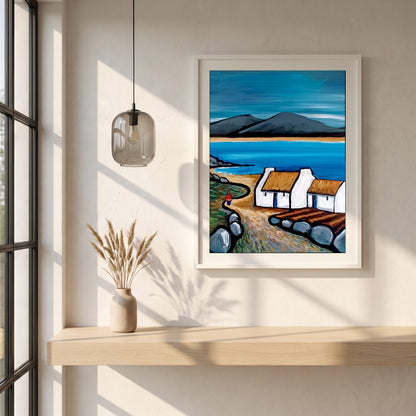 Connemara Lakes Cottage framed print in a white frame on a plaster wall above an oak worktop in a bright Scandinavian kitchen