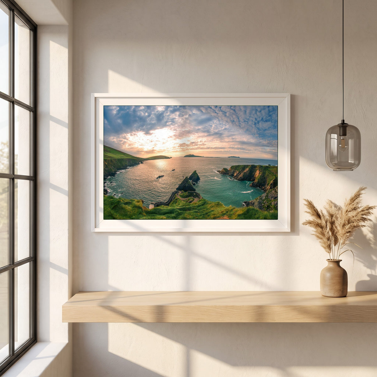 Dingle Peninsula framed print in a white frame on a plaster wall above an oak worktop in a bright Scandinavian kitchen