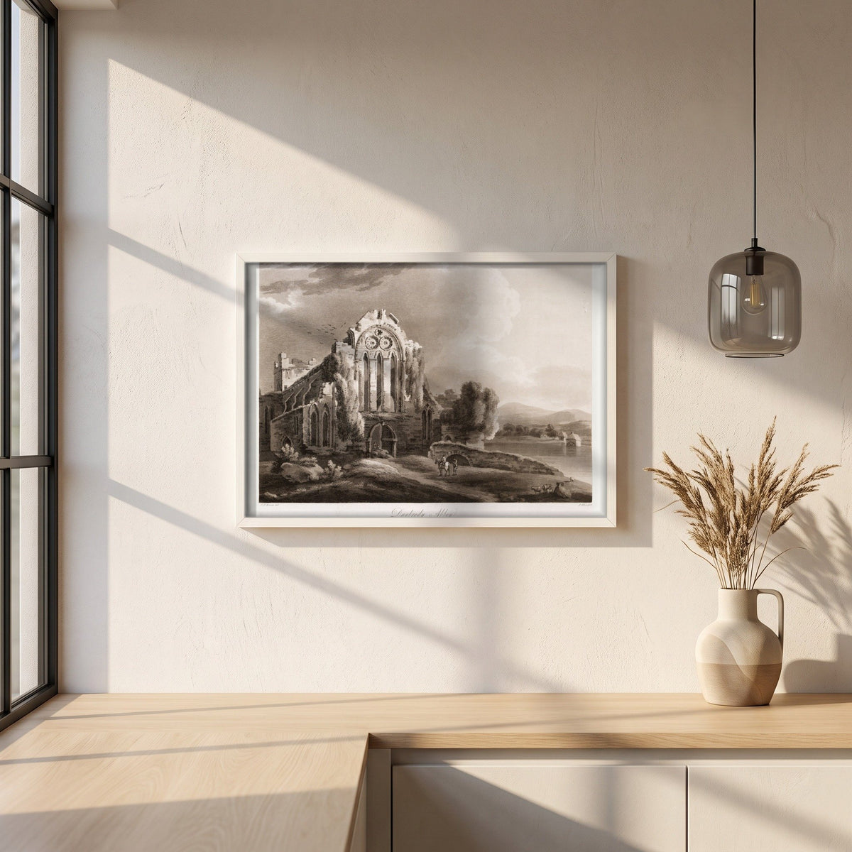 Dunbrody Abbey by Thomas Sautelle Roberts Art Print framed print in a white frame on a plaster wall above an oak worktop in a bright Scandinavian kitchen