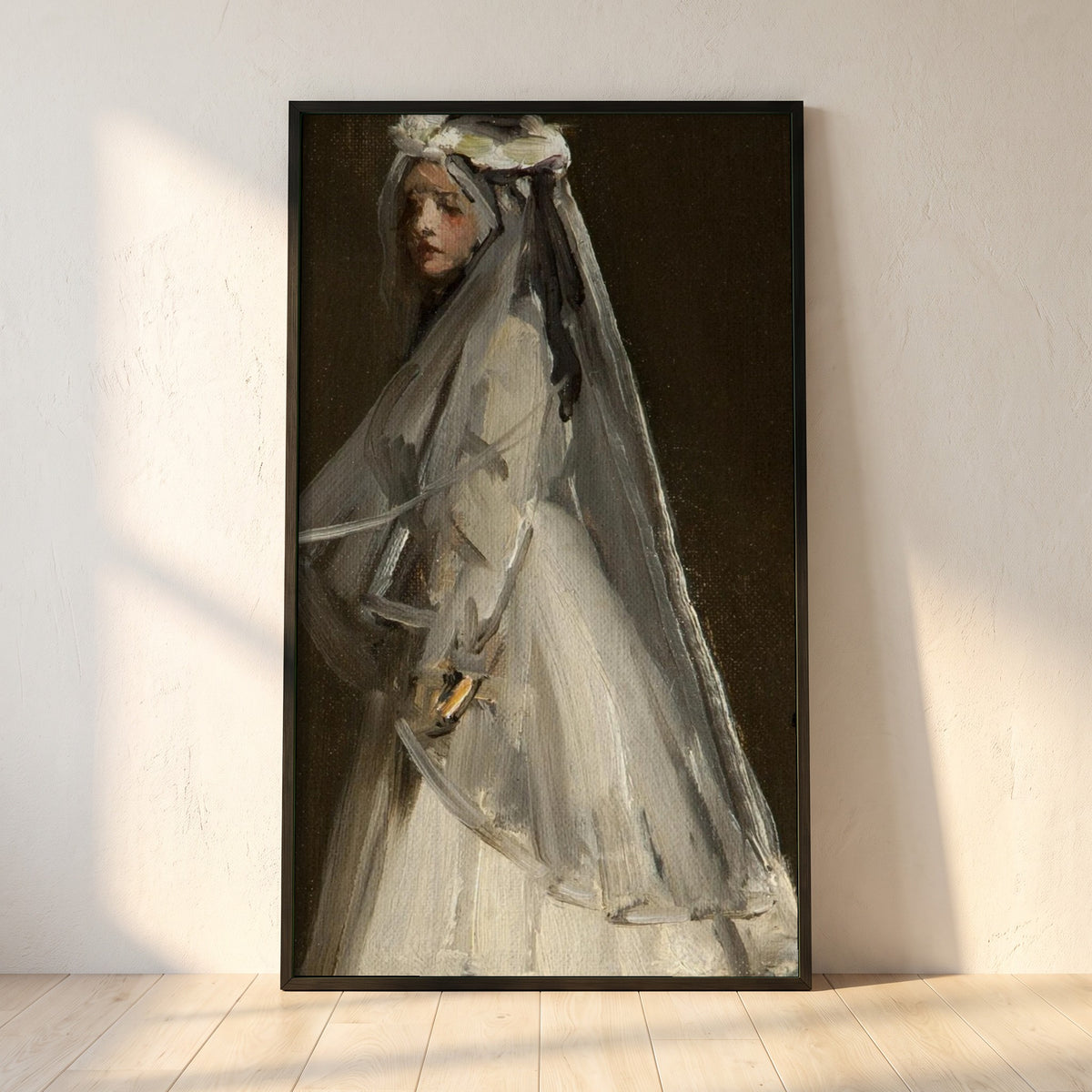 Eileen, Her First Communion framed print in a black frame leaning against a white plaster wall on oak floorboards in morning light