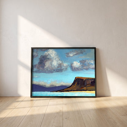 Fair Head from the Sea framed print in a black frame leaning against a white plaster wall on oak floorboards in morning light