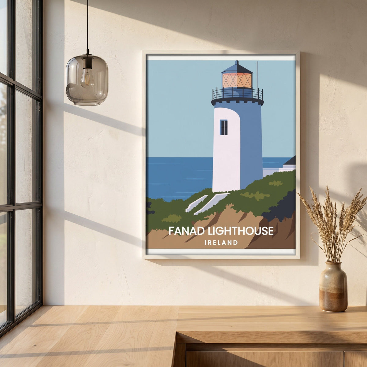 Fanad Head Lighthouse framed print in a white frame on a plaster wall above an oak worktop in a bright Scandinavian kitchen