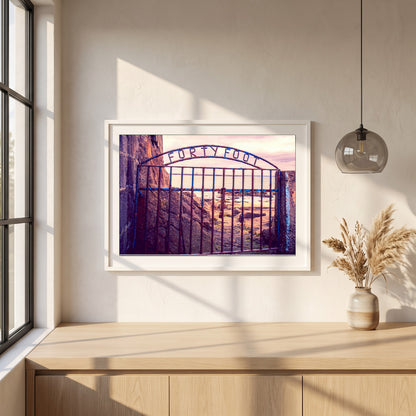 Forty Foot Gate Swimming Sandycove framed print in a white frame on a plaster wall above an oak worktop in a bright Scandinavian kitchen