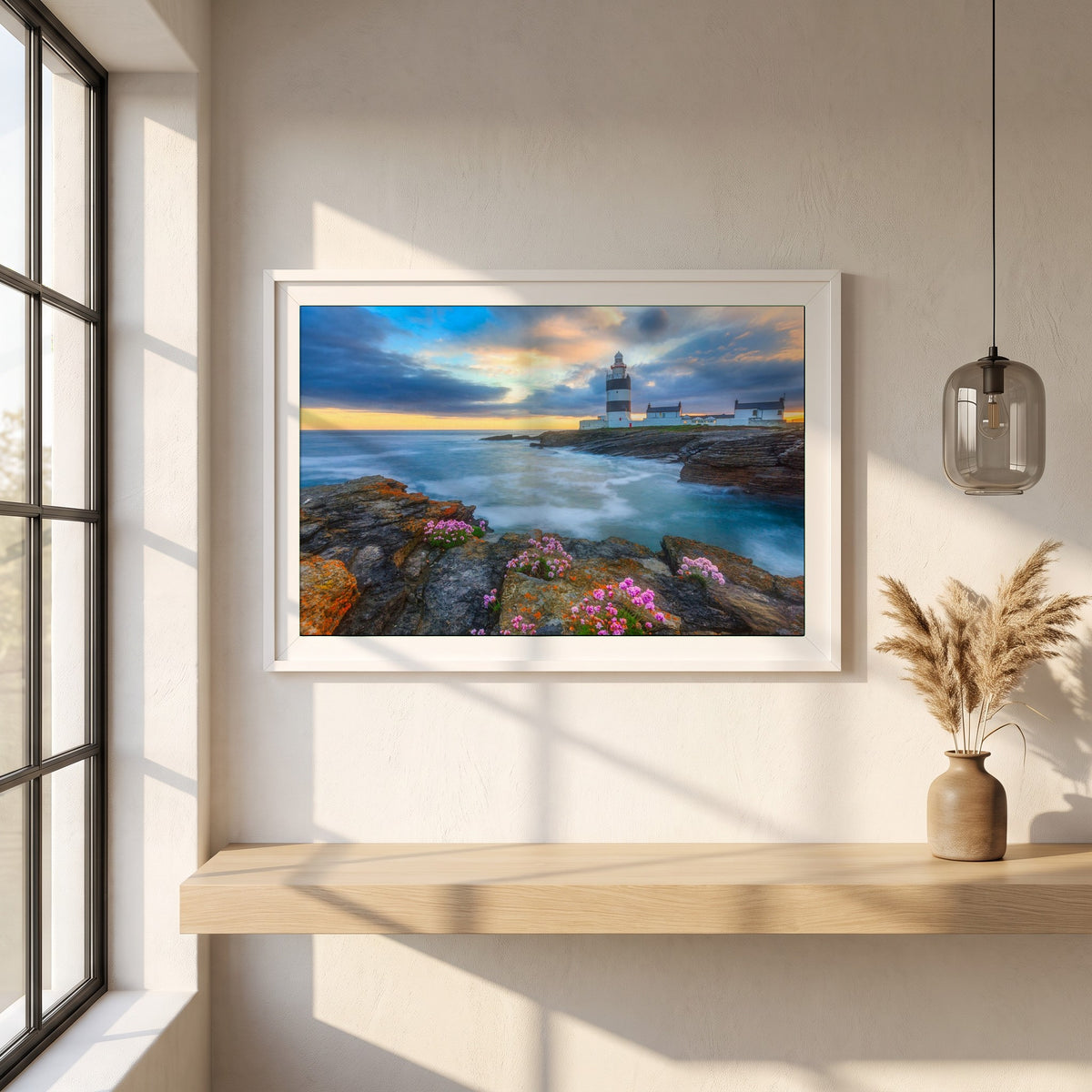 Hook Head Lighthouse, Wexford framed print in a white frame on a plaster wall above an oak worktop in a bright Scandinavian kitchen