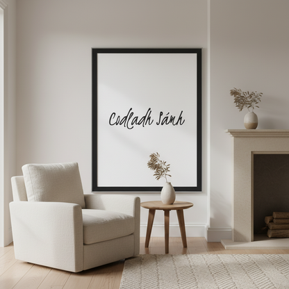Codladh Sámh Sleep Well Irish language print in a black frame above an armchair beside a fireplace